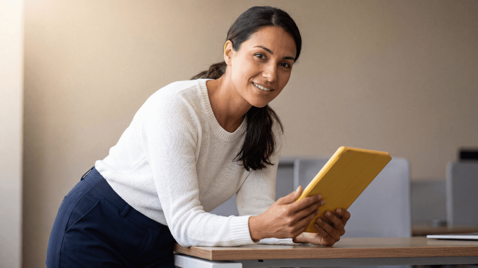 Woman with dark hair and white tshirt using yellow tablet