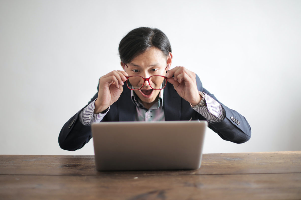 Amazed formal male looking at laptop-screen